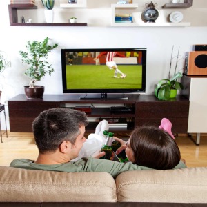 Couple watching futbol on television