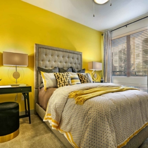 bright yellow bedroom area in 2 bedroom model