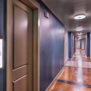 interior hallway at origin with lighted door numbers