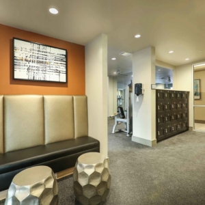Fitness area with club style wooden lockers and private sitting area