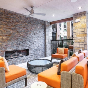 indoor-outdoor lounge area at Origin at frisco bridges featuring lounge furniture and a gas fireplace